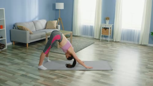 Woman Doing Yoga in Living Room at Home
