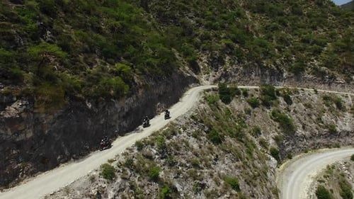 Aerial Of Motorcycle Riders Riding Motorbike On Mountain Roads