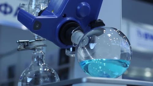 Rotating Flask of Blue Liquid in Laboratory