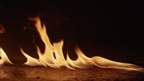 Bright Yellow Flames Flowing on Dark Background