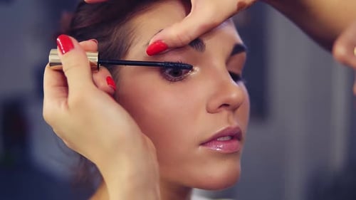 Professional Makeup Artist Applying Mascara on the Model's Eye