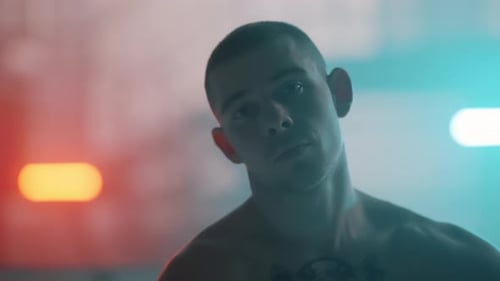 Intense Man Stares in Red and Blue Lighting