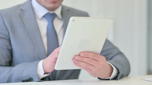 Close Up of Businessman Working on Digital Tablet