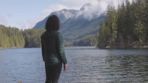 Woman Enjoys Scenic Mountain and Lake View