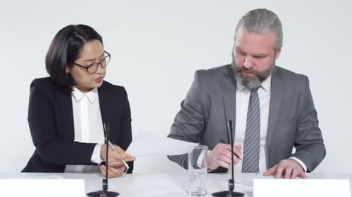 Business Meeting with People Taking Notes