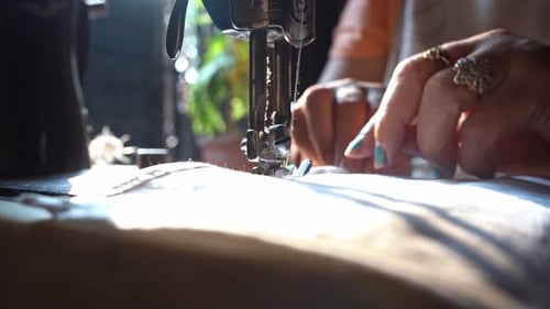 Lady Sewer On A Manual Sewing Machine Put A Hem On The Edge Of A Fabric In India. - Close Up Shot