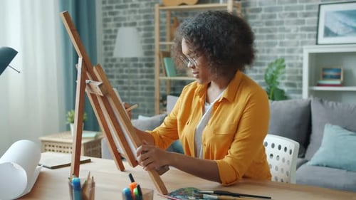 Woman Drawing on Canvas in Home Studio