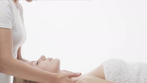 Junge, gesunde und schöne Frau wird im Spa-Salon massiert.
