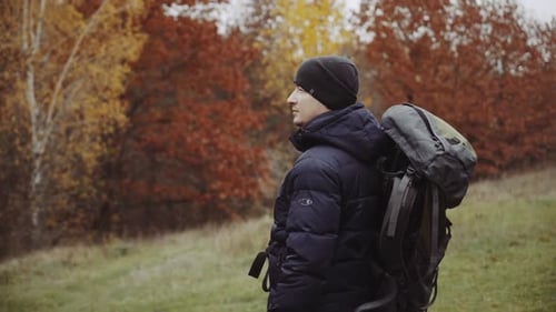 Man with Backpack Hiking During Fall Season