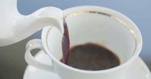Tea Being Poured into Delicate White Teacup