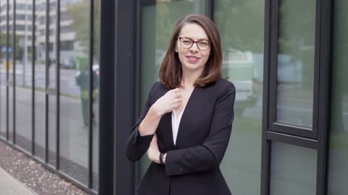 Confident Businesswoman Posing Near Modern Office Building