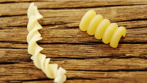 Various pasta on wooden table