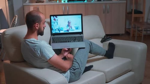 Man Has Telehealth Visit on Laptop at Home
