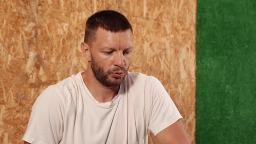 Sweaty Bearded Man Looking Off Camera in Gym
