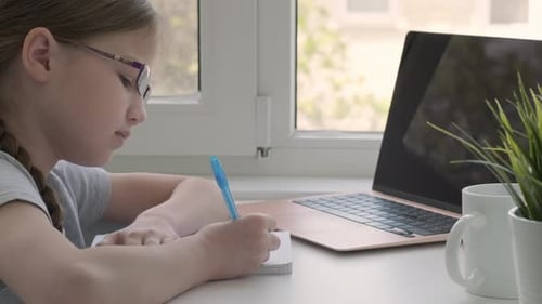 Cute Girl in Glasses Handwrite Study Online Using Laptop at Home Back to School