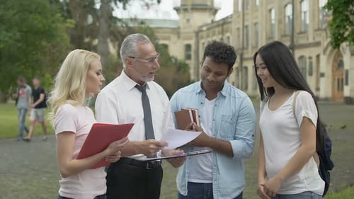 Physics Teacher Discussing Results of Scientific Research With Group of Students