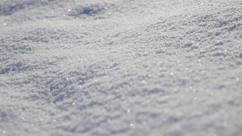 Close-up of snow dunes on the early morning 4K 3840X2160 UHD tilting video - Shallow DOF of frozen c