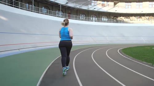 Woman Jogging on a Running Track