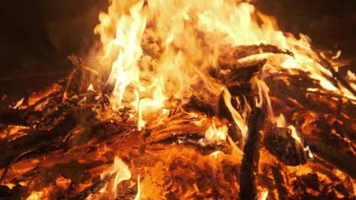 Hot Coals Burning Down a Large Fire and Glow Bright Red. Slow Motion