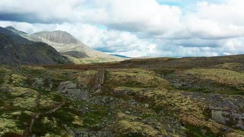 Majestic View From the Top of Mountain Ranges Under Cloudy Blue Skies