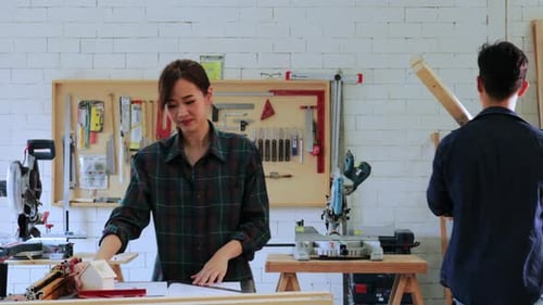 Asian woman student design construction for built-in furniture project in workshop