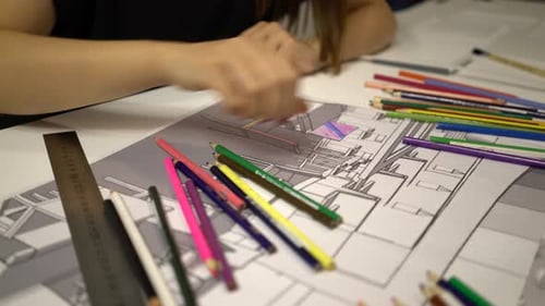 Architect Draws Architectural Sketch at a Table