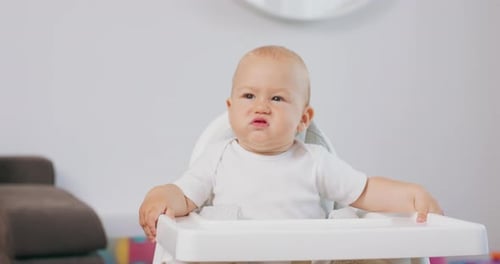 Adorable Infant Making Funny Unhappy Faces