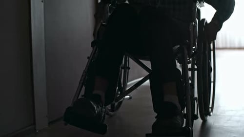 Silhouette of Male Patient Riding Wheelchair