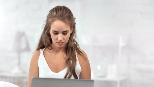 Young Adult Woman Using Laptop Indoors