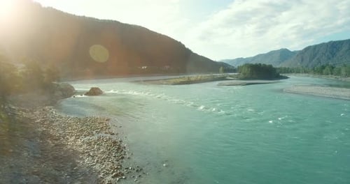 Low Altitude Flight Over Fresh Fast Mountain River with Rocks at Sunny Summer Morning.