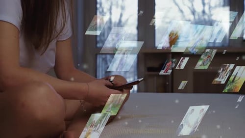 Woman Scrolls Through Images on Smartphone in Bedroom