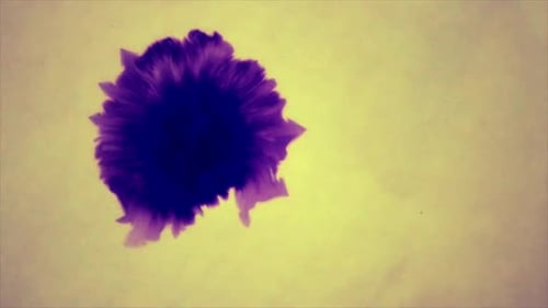 Purple Ink Blot Spreading across Yellow Paper