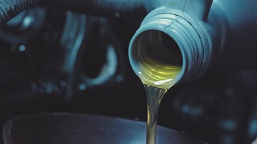 Auto Mechanic is Changing Motor Oil