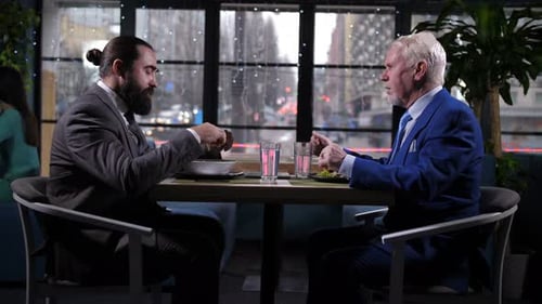 Businessmen at Restaurant Having a Discussion