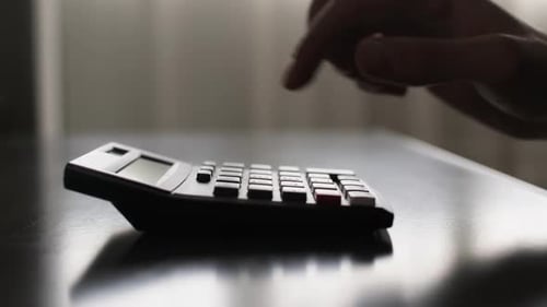 Silhouette der männlichen Hand mit Taschenrechner