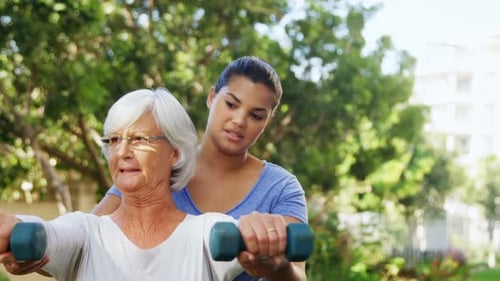 Senior Woman Exercising with Weights in Garden