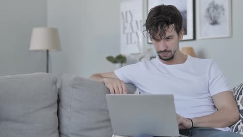 Man Video Calling on Laptop at Home