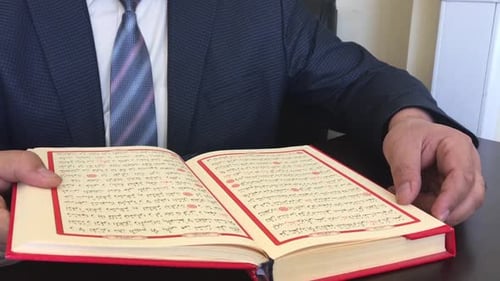 Reading Islamic Quran at Desk