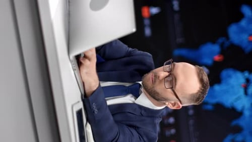 Focused Man Works on Laptop in Office