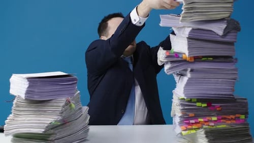 Overwhelmed Man with Too Much Paperwork