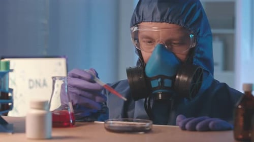 Scientist in Protective Clothing Studying DNA in Lab