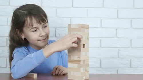 A child is playing with wooden blocks.