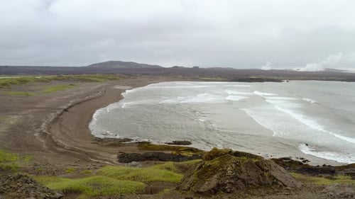 Bird's Eye View Of Ocean Waves Splashing On Sandy Beach In The Reykjanes Peninsula, Iceland - aerial