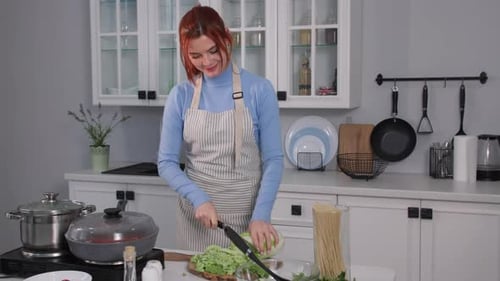 Diet Dish Adorable Young Housewife Prepares Fresh Green Vegetable Salad Pours Into a Bowl and Mixes