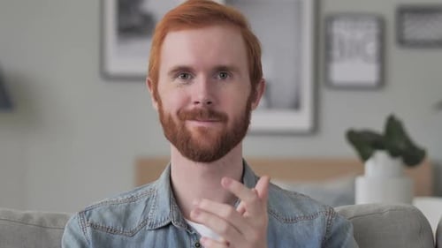Close-Up of Red-Haired Man Clapping Indoors