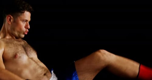 Male Athlete Kickboxing with Punching and Kicking on Black