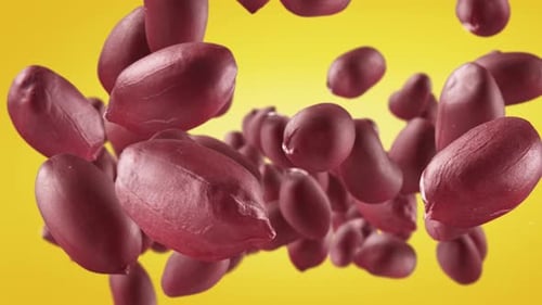 Peanuts Floating Upwards on a Yellow Background