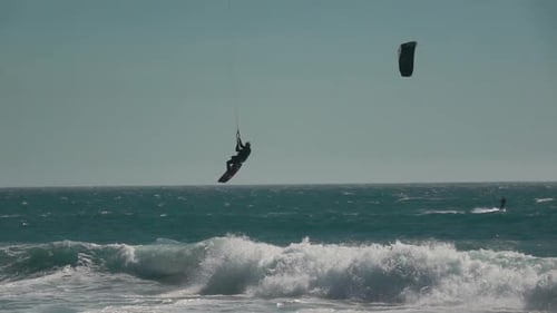 Kite Surfer Performing Tricks in Ocean Waves