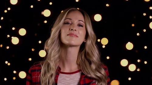 Blonde Woman Smiling in Front of Bokeh Lights