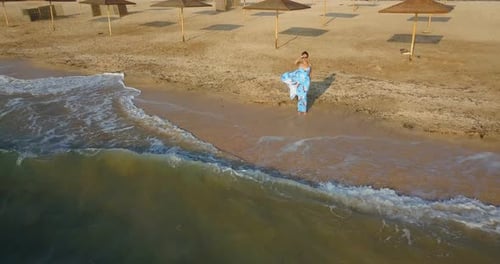 girl on the beach in a dress near the sea